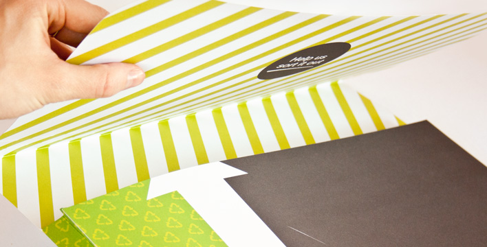 The inside flap of the Recycling at Work promotional wallet features vibrant green stripes and the tagline: Help us sort it out.